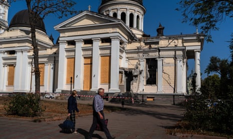 People pass by the Transfiguration Cathedral in Ukraine, which was damaged by a Russian missile strike on 23 July.
