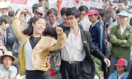 A young unidentified couple pass the time in Tiananmen Square with a lively dance.