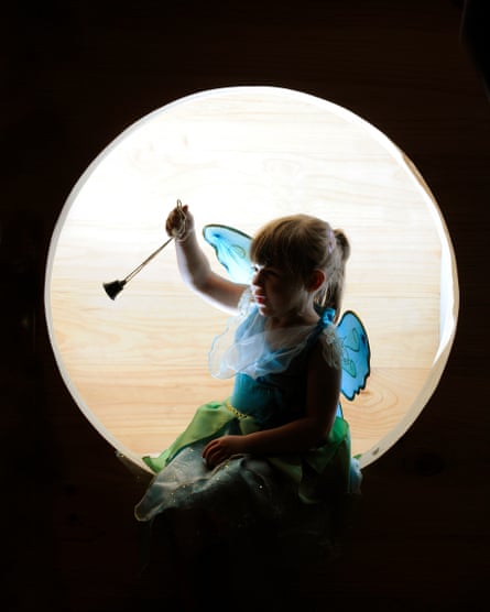 A little girl holds the original Tinker Bell (a small bell that JM Barrie bought to be rung whenever his fairy character appeared in the original stage version of the story).