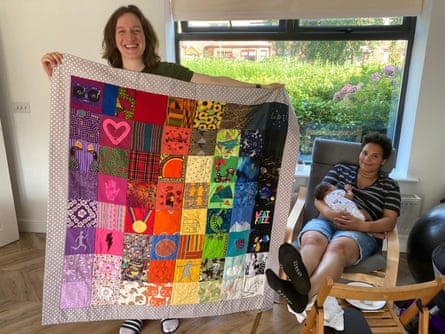 Lucy (left), Vee and their baby, Asher, with a quilt made for them by Ruth Evans