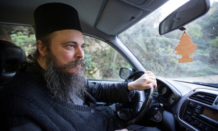 Father Theophilos drives his car to the capital Karyes.