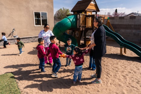 young children and women holding hands