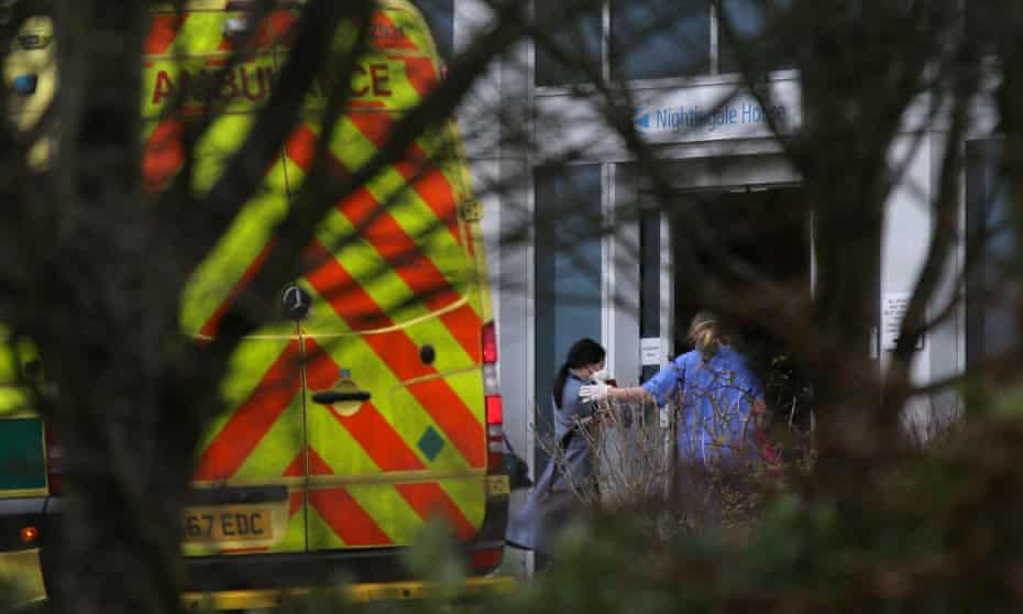 Medical personnel escort British nationals evacuated from Wuhan, China, to Kents Hill Park hotel in Milton Keynes on 9 February.