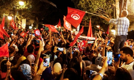 People celebrating in the streets of Tunis after exit polls suggested a win for Kais Saied in Tunisia’s presidential election. 