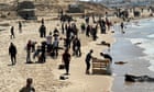 Twelve people reported drowned off a Gaza beach trying to reach aid drop
