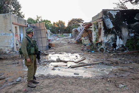 a soldier stands in a destroyed area