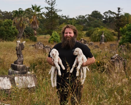 Craig Homan smiles with two of his baby goats