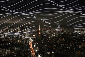 White wavy lines in front of a night-time cityscape
