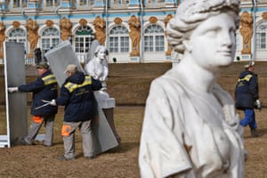Museum workers take down protective wooden crates of Venetian marble statues on Hermitage Alley in St Petersburg