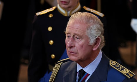 King Charles III walks as the coffin of Queen Elizabeth II arrives at Westminster Hall in London.