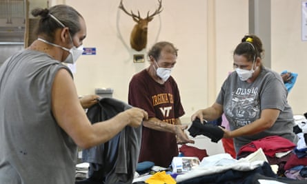 Evacuees of the flooding in eastern Kentucky gather clothing at the Knott county Sportsplex in Leburn on Friday.