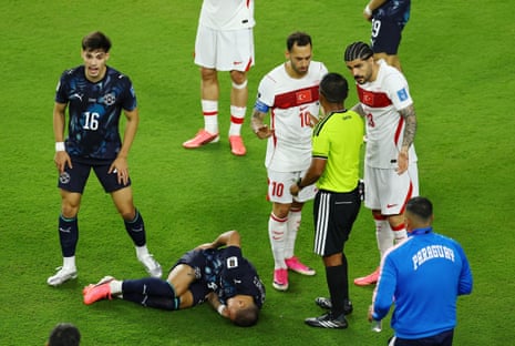 Paraguay's Juan Jose Caceres reacts as Turkey's Hakan Calhanoglu and Eren Elmali remonstrate with referee Ivan Barton.