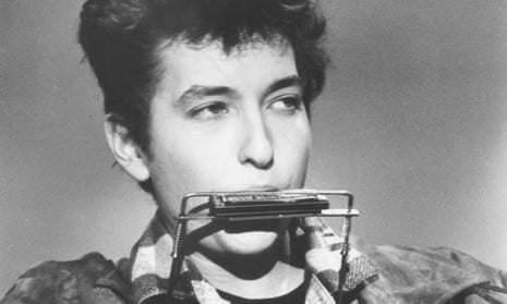 Bob Dylan in 1962 playing the harmonica
