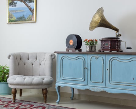 A vintage blue sideboard, plump chair and wind-up gramophone