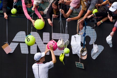 Jannik Sinner signs autographs for fans who have turned out in force for a practice session during Opening Week at the Australian Open