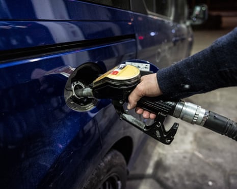 A person is pumping gasoline at a petrol station that shows prices well over EUR 2.00 in Berlin, Germany.