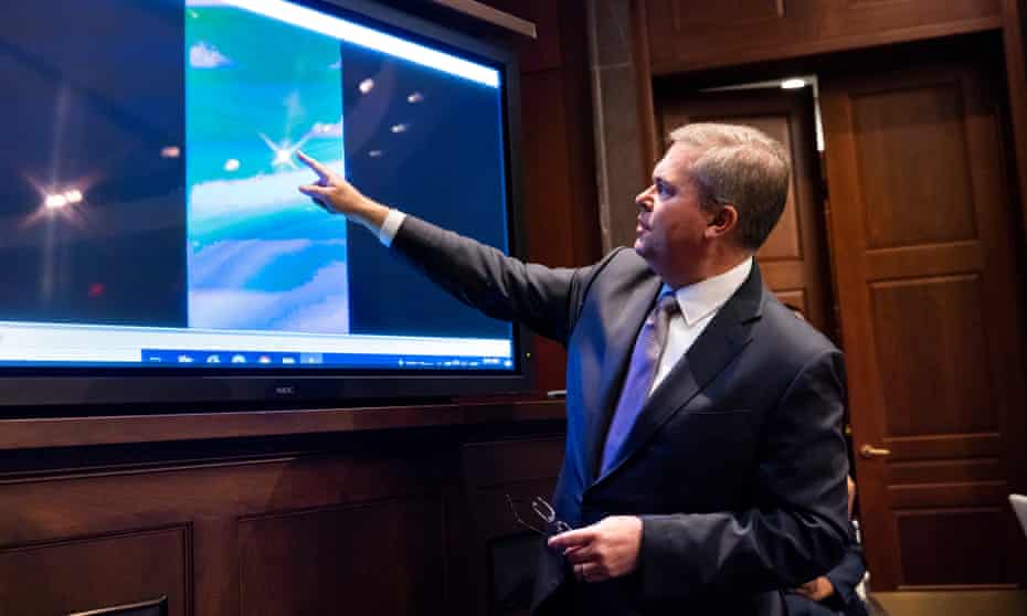 Deputy director of Navy intelligence Scott Bray plays a video of an 'unidentified aerial phenomena’ at the briefing. 