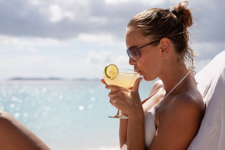 Woman sipping a margarita by nan sea