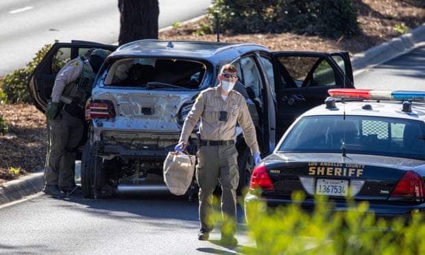 LA county deputies gather evidence from Woods’s car after the accident.