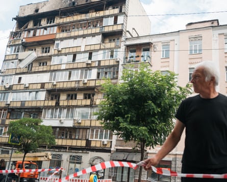 Man next to tape near damaged block