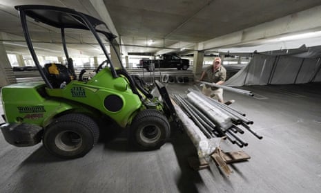 Jay McCullough arranges tent poles as a team of event specialists start to convert a parking garage at the University of Mississippi Medical Center into a field hospital on Wednesday in Jackson, Mississippi.