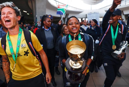Janine van Wyk, Refiloe Jane and Andile Dlamini arrive at Johannesburg’s airport after winning the 2022 Women’s Africa Cup of Nations.