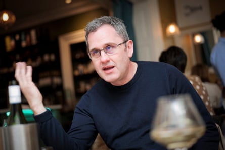 Carl gesticulating at the restaurant table