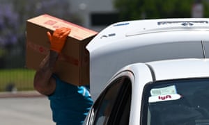 Rideshare drivers receive hand sanitizer and face masks at an event organised by the Mobile Workers Alliance. Drivers say Lyft should provide protective gear for free.