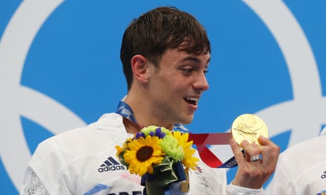 Tom Daley with the medal he has knitted to protect.