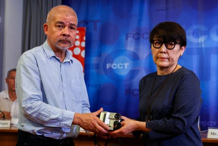 Aye Chan Naing, co-founder of the Democratic Voice of Burma (DVB), and Kenji Nagai’s sister Noriko Ogawa hold Nagai’s MiniDV camera