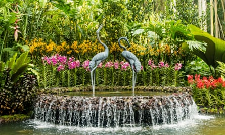 Elegant sculpture of cranes in a cascading fountain surrounded by beautiful orchids in the Orchid Garden, Singapore Botanic Gardens