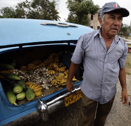 A farmer sells his produce out of the boot of his car at a market in the village of Sagua La Grande in central Cuba.