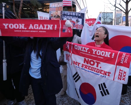 Supporters of Yoon Suk Yeol hold up banners and flags
