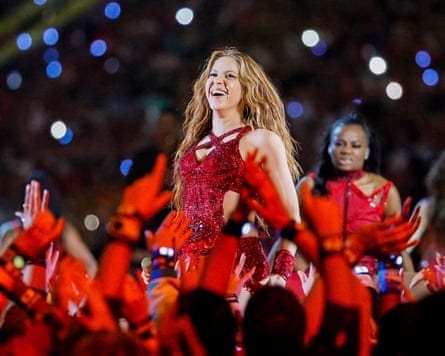 Shakira in a red outfit on stage