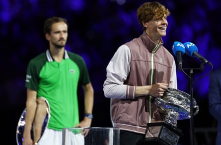 Jannik Sinner (right) speaks to the media as Daniil Medvedev contemplates his defeat.