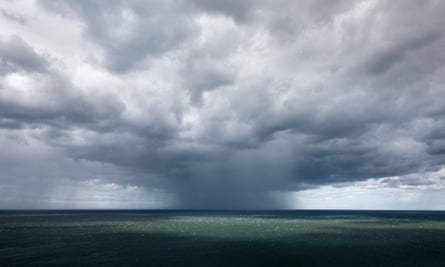 A cloud releases a deluge of rain off Flamborough cliffs in East Yorkshire, England.