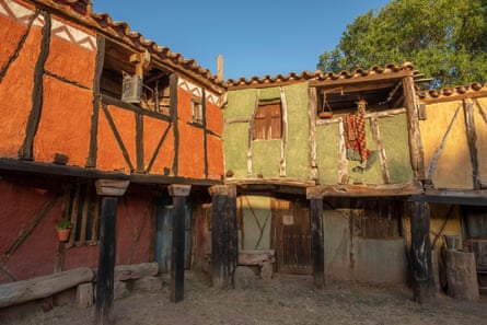 View of a reproduction of a medieval porticoed building painted red, green and yellow