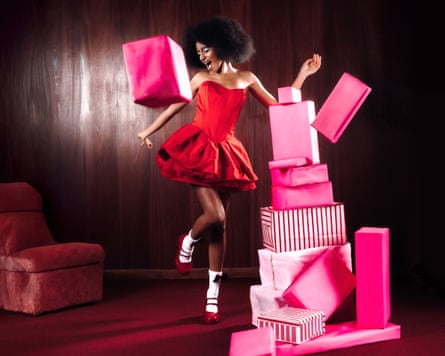 Flowerovlove in a pink party dress surrounded by pink wrapped boxes
