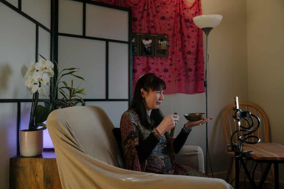 Eileen Dey Wurst hosts a free virtual sharing circle and healing meditation using Zoom video conferencing at her home on Sunday, March 15, 2020, in Seattle, Wash. Wurst created an online coronavirus support group on MeetUp to offer a safe space for individuals to process recent events. Photograph: Jovelle Tamayo/The Guardian