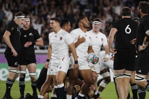 England’s Manu Tuilagi, center right, celebrates with teammates after scoring a try.