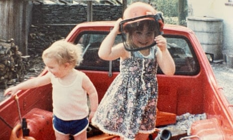 The author as a child and her brother, Tom, on their father’s pick-up truck circa 1987.