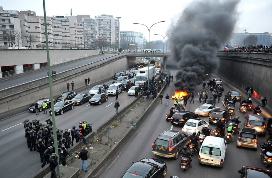 Taxi drivers demonstrate by blocking the traffic on a peripherique, on January 26, 2016 in Paris, France
