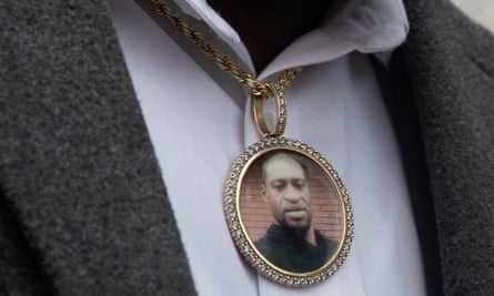 An image of George Floyd hangs from a necklace worn by a family member after a prayer session in Minneapolis in April 2021.