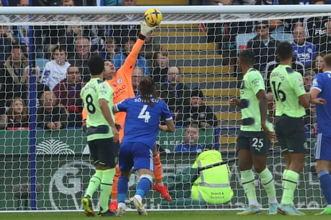 Manchester City's goalkeeper Ederson saves a shot from Leicester City's Youri Tielemans.
