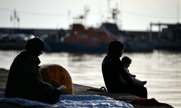 Women sit at Chios port