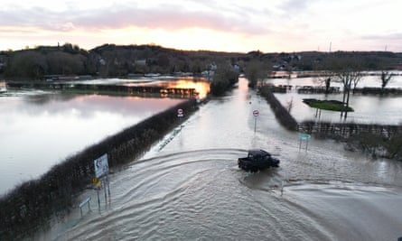 A car makes it’s way through flood water.