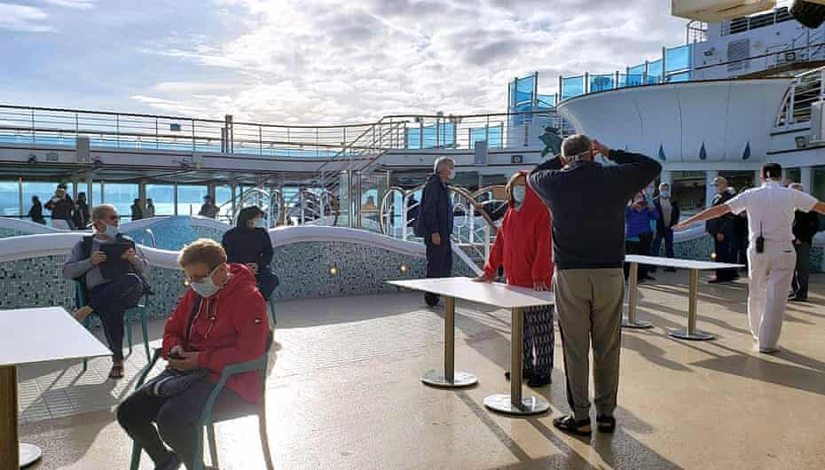 Passengers wear masks on the deck of the Grand Princess cruise ship.