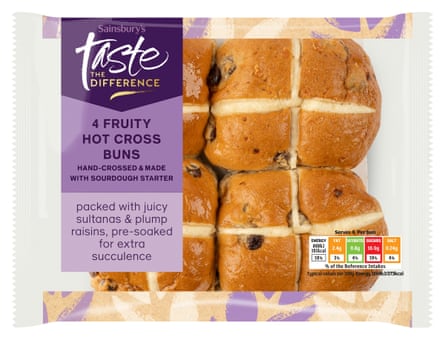 Four Sainsbury’s taste the difference hot cross buns in a clear packet with a purple label