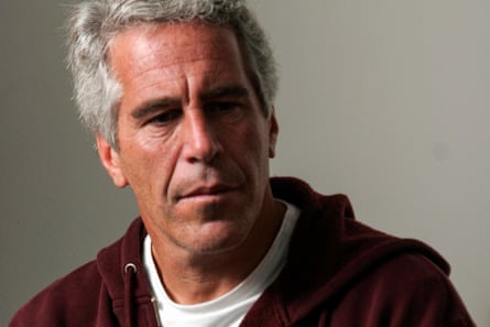 a man in a hoodie looks off to the side