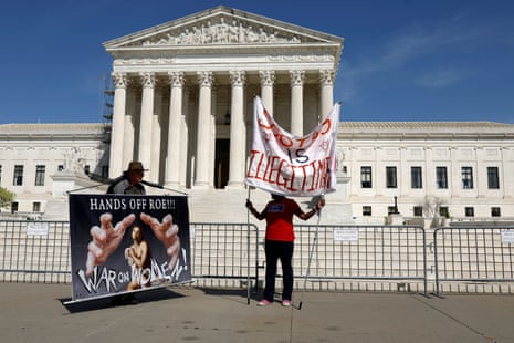 Abortion-rights activists hold up signs outside the US supreme court building on 19 April in Washington DC. 